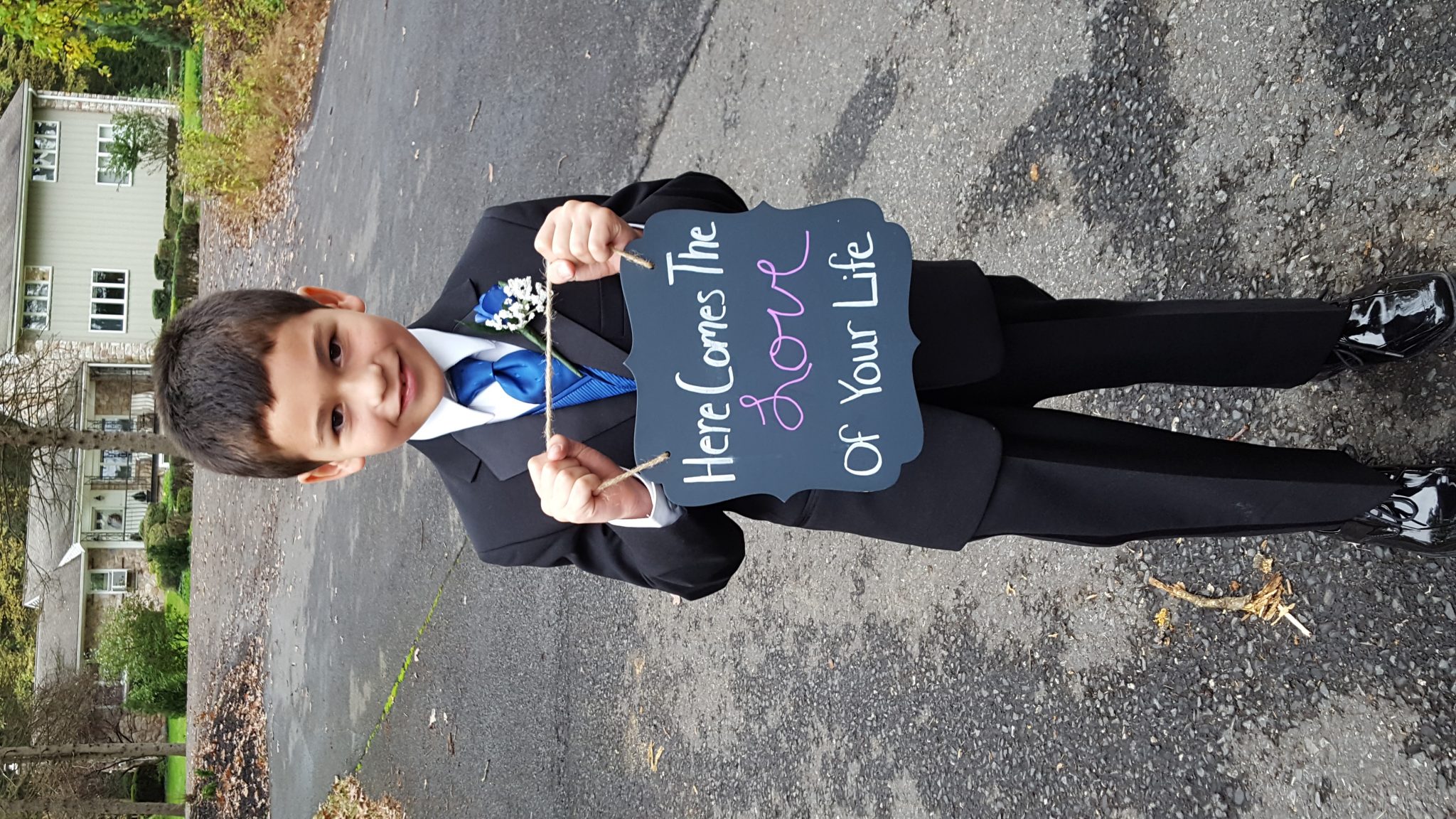 A child with a suit posing for a photo